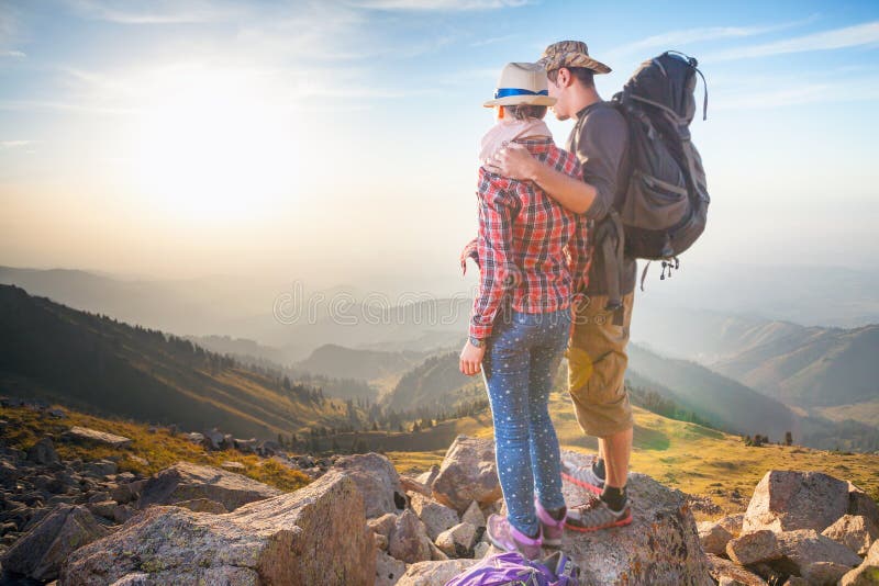 Climbing young couple at top of summit with aerial view stock photos Climbing young couple at top of summit with aerial view stock photos