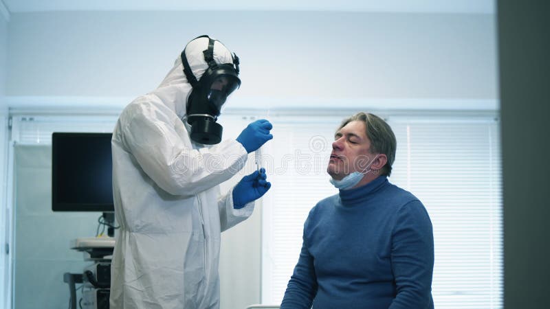 A clinic worker takes man`s smear for coronavirus test during coronavirus pandemic. Coronavirus, covid-19 Infected