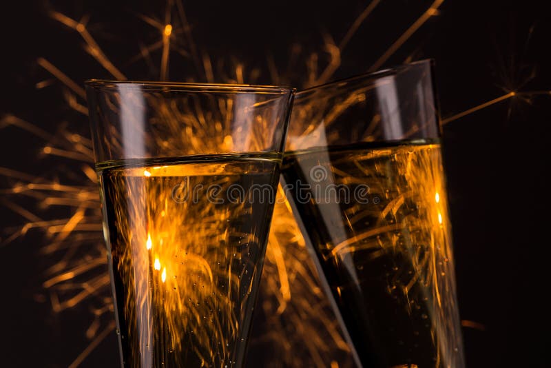 Clink glasses with fireworks background on new year s eve