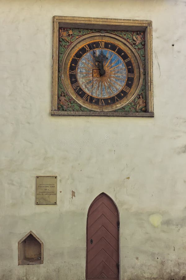 Clock And A Door On An Old Church Wall. An old clock and a wooden door on the wall of the Church of the Holy Spirit in the old town of Tallinn, Estonia royalty free stock photos Clock And A Door On An Old Church Wall. An old clock and a wooden door on the wall of the Church of the Holy Spirit in the old town of Tallinn, Estonia royalty free stock photos
