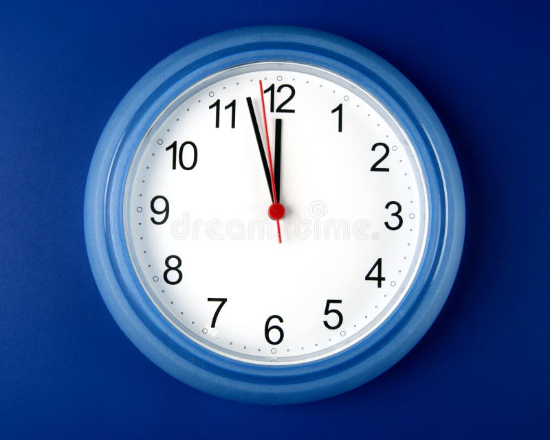 Clock about to hit midnight or noon on blue backgr
