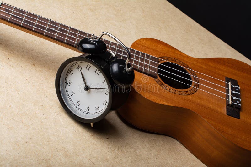 Clock and ukulele stock image. Image of small, detail 243573529