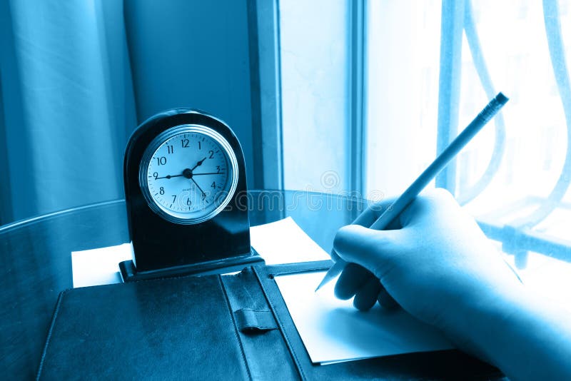 Clock and writing hand on note