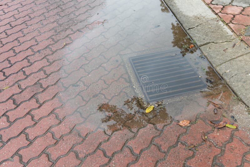 Clogged underground drain with water over flow after rain storm