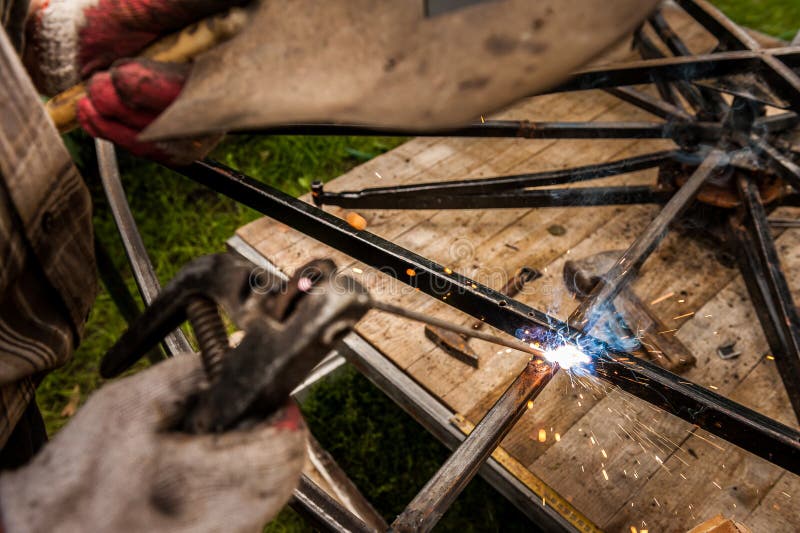 Close hand man arc welding or stick welding iron stock images