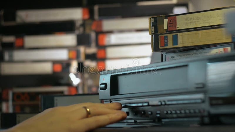 Hand inserted VHS into the VCR stock footage