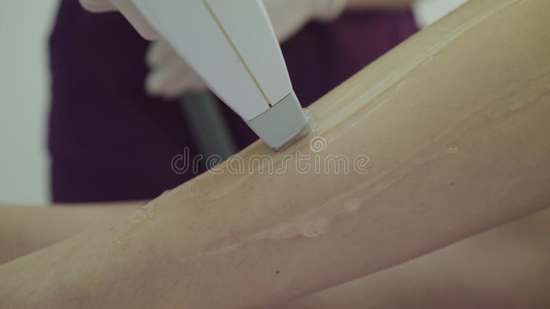 Close laser hair removal on female slim legs lying on couch in treatment room