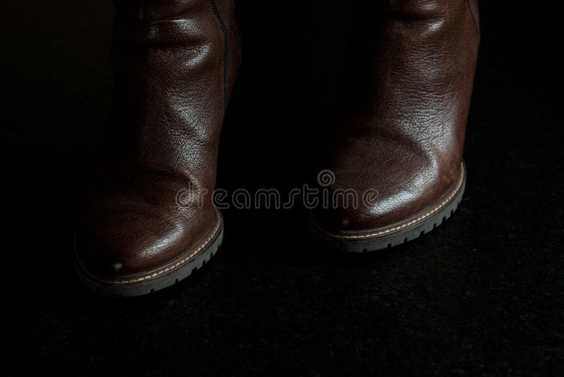 Close Shot of Brown Leather Boots on a Black Surface Stock Image