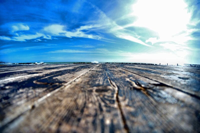 Close shot of a wooden surface under a cloudy sky.