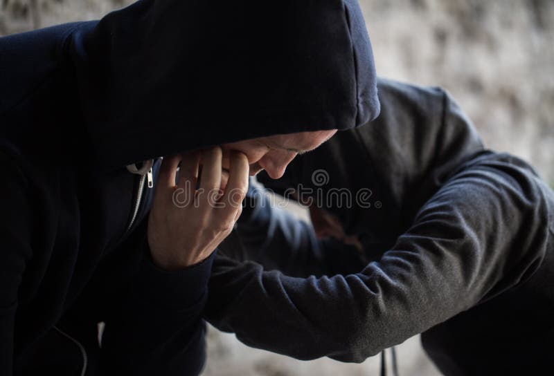 Substance abuse, addiction, people and drug use concept - close up of addicts on street