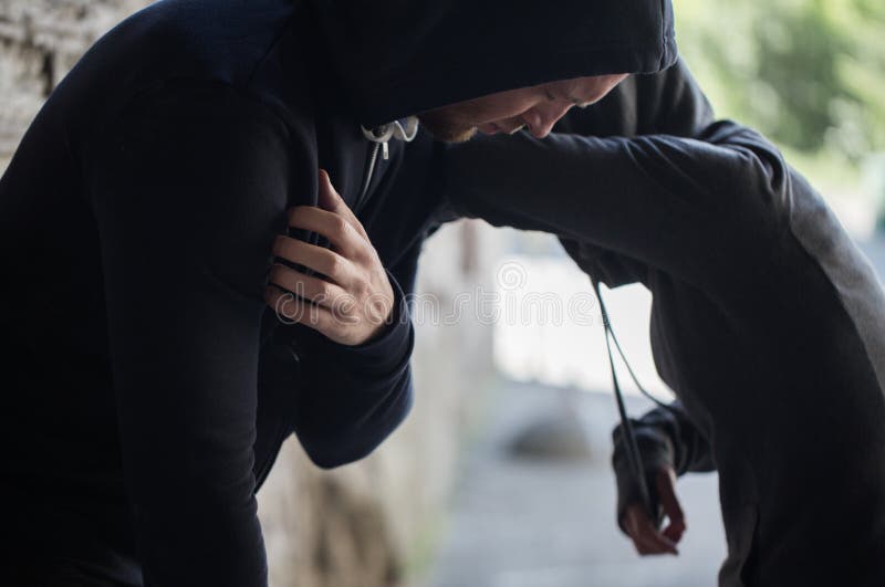 Substance abuse, addiction, people and drug use concept - close up of addicts on street