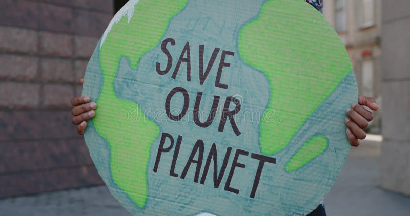 Close up of african american person holding Earth model with save our planet writing. Female hands with poster during
