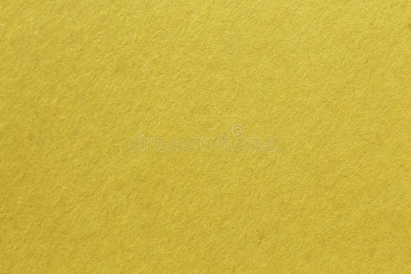 Close up aka macro shot of yellow construction paper, showing texture, paper fibers, flaws, and more. the perfect image for all