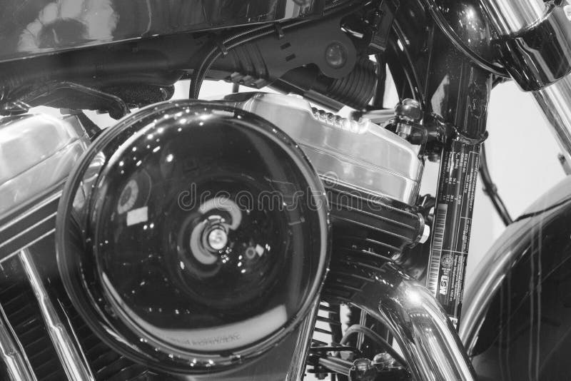 Close up of American heavy vintage motorcycle of a famous brand on showcase, power v twin engine elements, part close-up, motorbike with shiny chrome detail in monochrome, black and white backgrounds