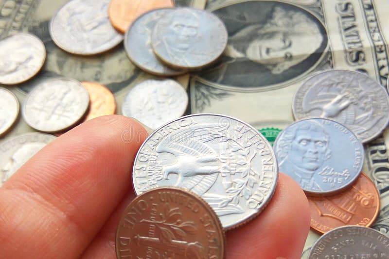 American quarter, dime coins in hand on dollar usa background royalty free stock photo American quarter, dime coins in hand on dollar usa background royalty free stock photo