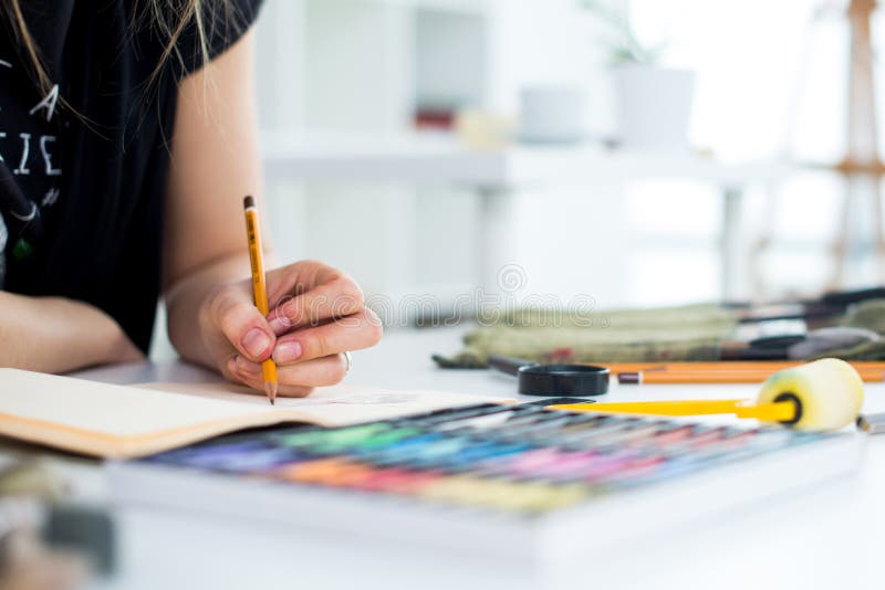 Female Painter Drawing in Art Studio Using Easel. Portrait of a Young ...