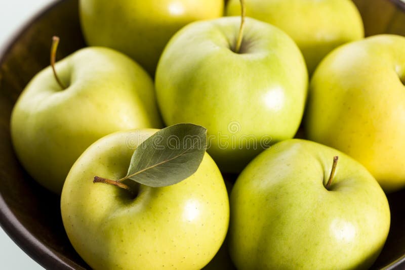 Close up of apples in wooden basket.