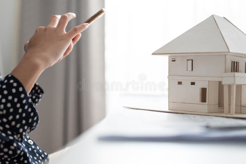 Close Up Architect or Engineer Hand Using Smartphone with Architectural Model Stock Image