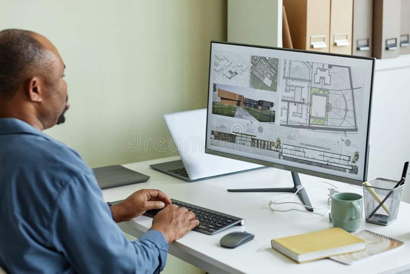 Close Up of Architect Using Computer with 3D Blueprints Stock Photo