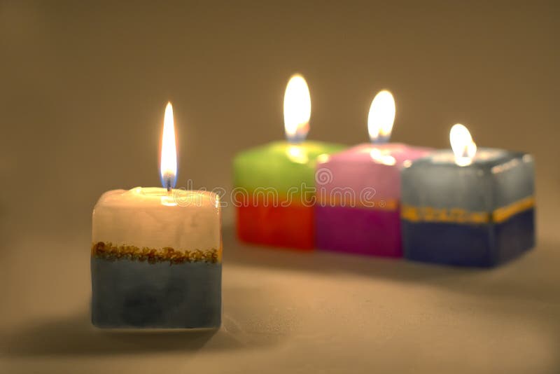 Lit tea candles and candles with copy space on black background Stock Photo  by Wavebreakmedia