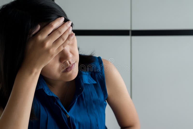 Close up of woman depression have a headache and feeling sadness in bedroom