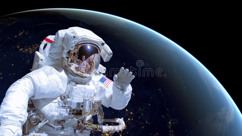 Close up of an astronaut in outer space, earth by night in the background stock photography