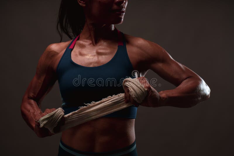 Close up of athletic healthy lean tone top body of asian woman holding white strap with both hands preparing for training or royalty free stock photography Close up of athletic healthy lean tone top body of asian woman holding white strap with both hands preparing for training or royalty free stock photography