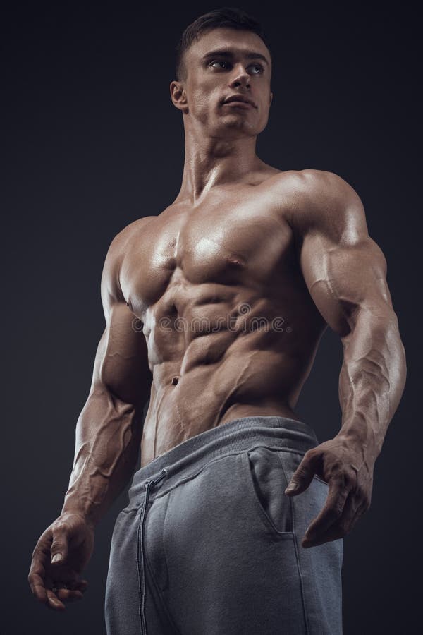 Close-up of a power fitness man. Strong and handsome young man with muscles and biceps. Studio shooting on black background. Close-up of a power fitness man. Strong and handsome young man with muscles and biceps. Studio shooting on black background.