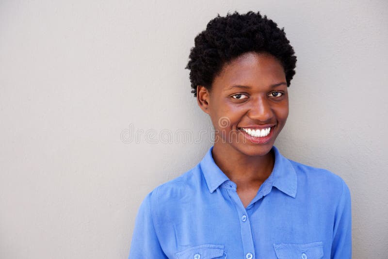 Close up attractive young african woman smiling on gray background stock images Close up attractive young african woman smiling on gray background stock images