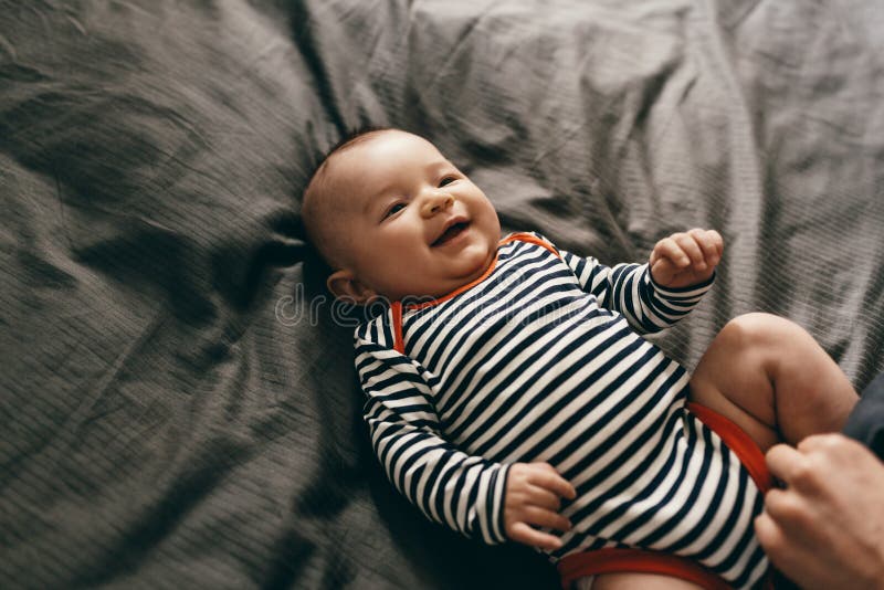 Close up of baby lying on bed