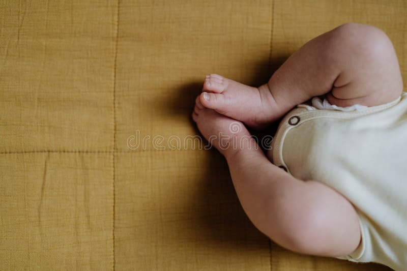 Closeup of Babys Legs Lying in Bed. Stock Photo Image of little