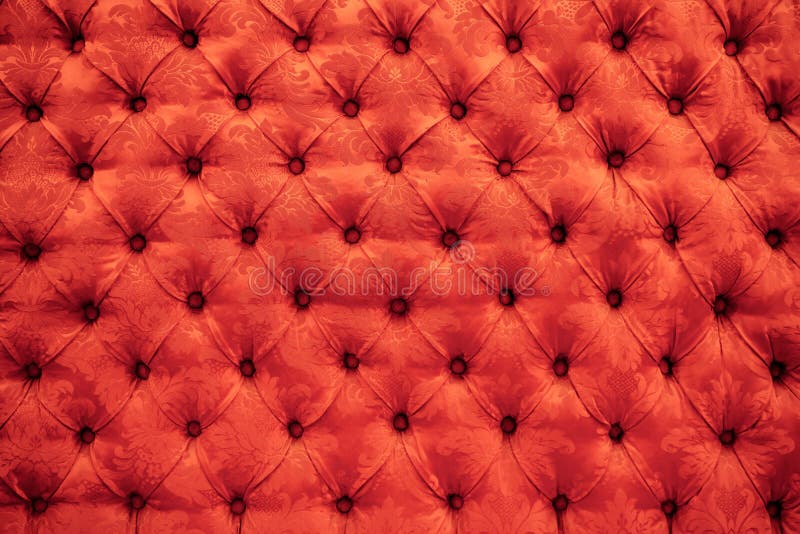 Close up background texture of scarlet red capitone genuine leather, retro Chesterfield style soft tufted furniture