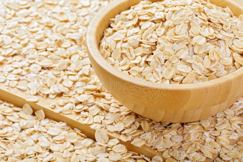 Close Up of a Background of Whole Grain Rolled Oats Stock Photo Image