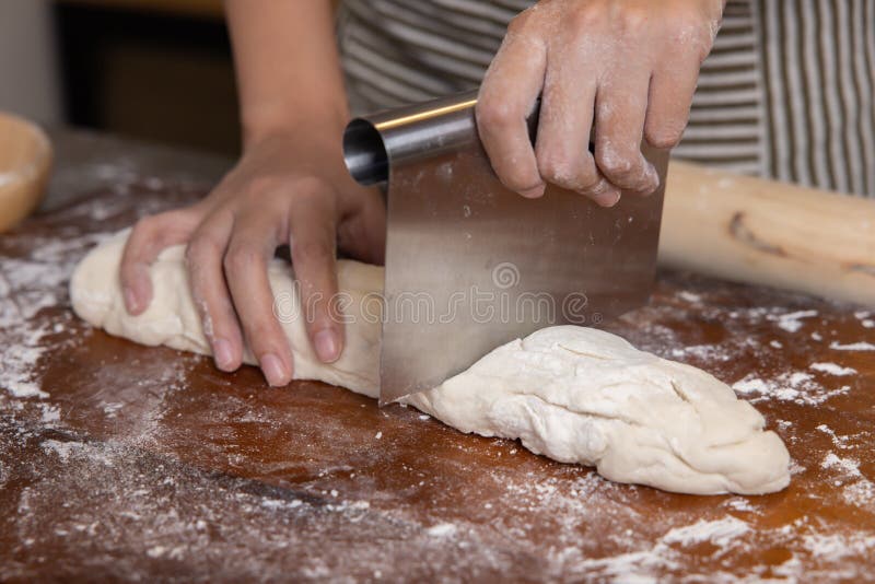 Baker S Hand Taking Some Chopped Nuts for Powdering Rolls Using Scoop