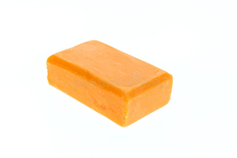 Close up bar of orange carrot soap isolated on white