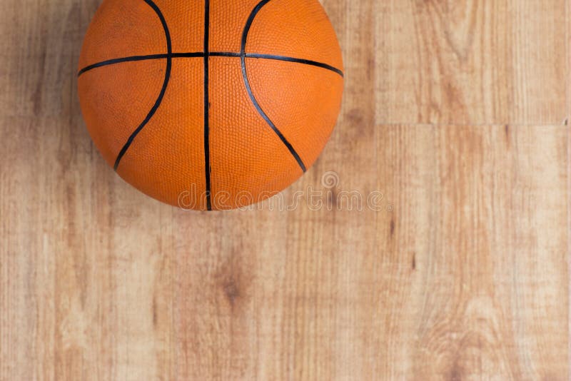 Close up of basketball ball on wooden floor