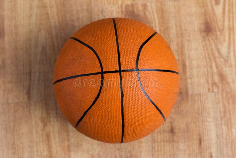 Close up of basketball ball on wooden floor