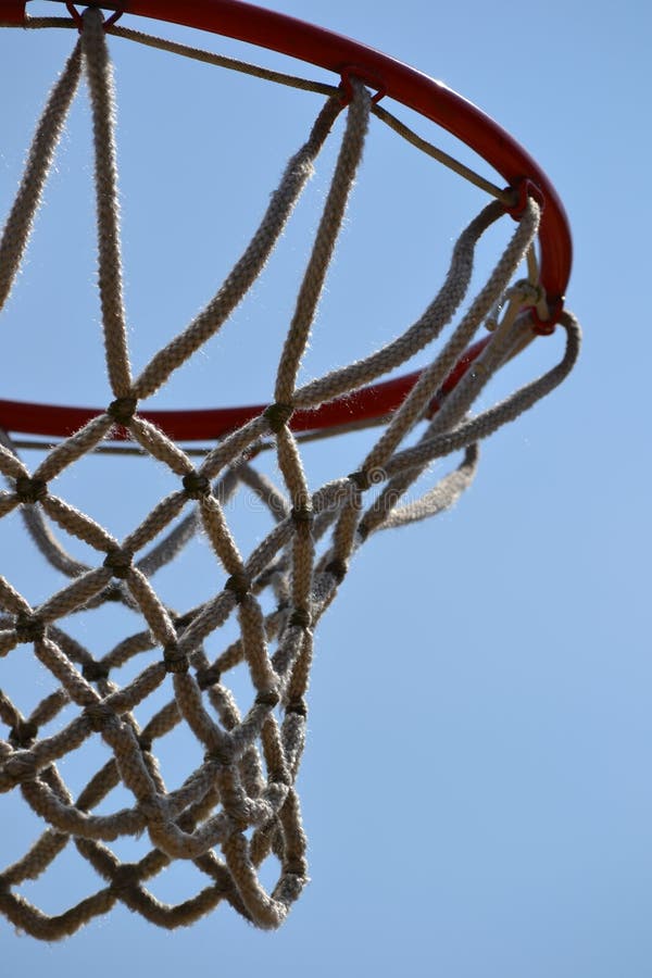 Close up of basketball goal/net with blue sky background