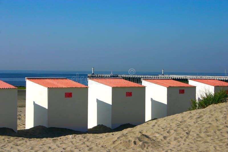 Close Up Beach Cabins with pier in background