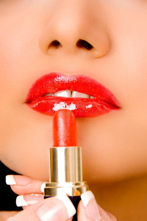 Close up of beautician applying lipsticks