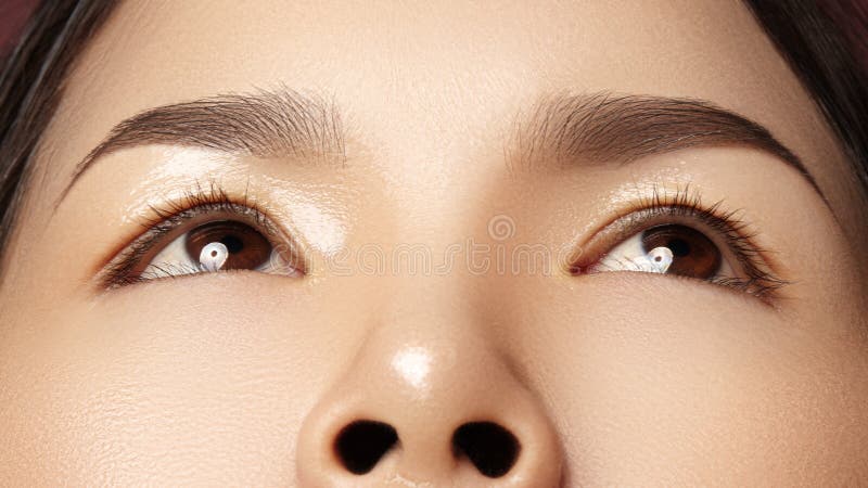 Close-up of Beautiful Asian Female Eye with Perfect Shape Eyebrows. Clean skin, Fashion Naturel Make-Up. Good Vision stock image Close-up of Beautiful Asian Female Eye with Perfect Shape Eyebrows. Clean skin, Fashion Naturel Make-Up. Good Vision stock image