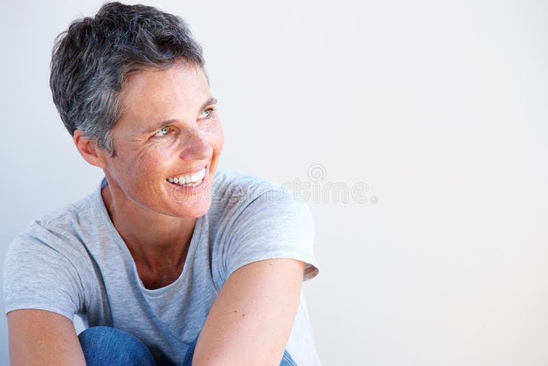 Close up beautiful older woman smiling against white background