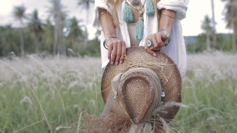Close up of beautiful young stylish woman hands holding hat outdoors at sunset stock video footage