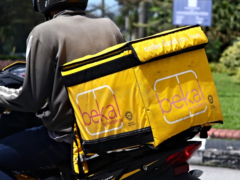 Close-up of the "bekal by foodpanda" thermobag food container placed on the back of a motorbike. bekal is an end-to-end halal-certified by Jakim food delivery service in Malaysia. Close-up of the "bekal by foodpanda" thermobag food container placed on the back of a motorbike. bekal is an end-to-end halal-certified by Jakim food delivery service in Malaysia