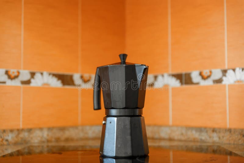 Closeup of Black Coffee Pot on Top of a Ceramic Hob Stock Photo