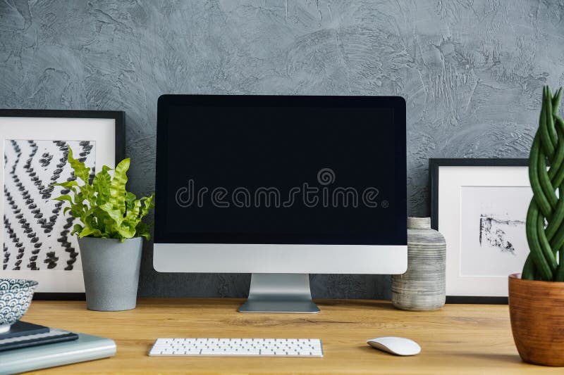 Close-up of a black, empty screen, plants, keyboard and painting stock images