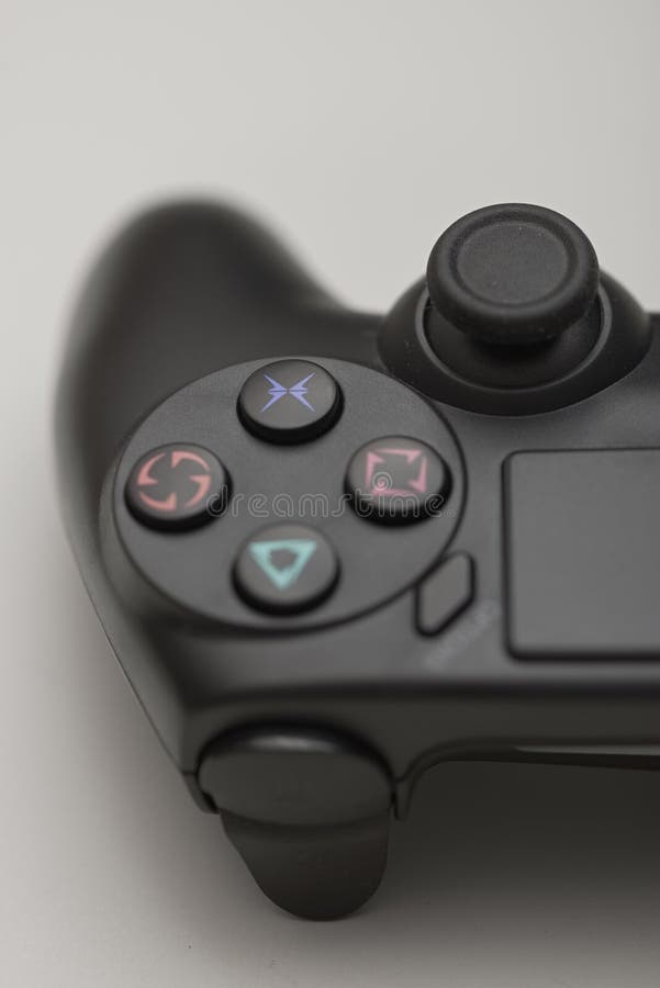 Close up of black game controller action buttons and analog joystick isolated on neutral background for gaming and console use stock images