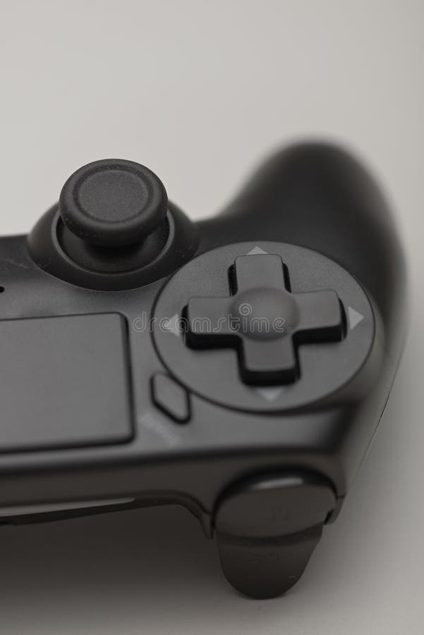 Close up of black game controller directional pad and analog joystick isolated for gaming and technology concepts royalty free stock photo