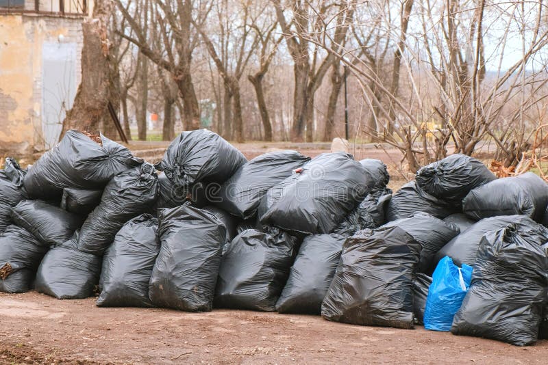 Environmental unfriendly disposed styrofoam plates and cups in garbage bags  Stock Photo