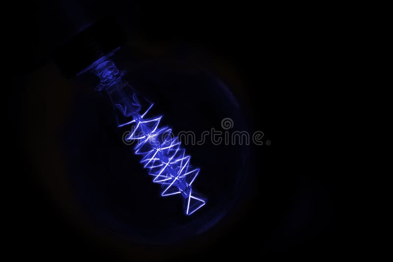 Close Up On Blue Light Bulb Glowing In Dark Stock Image Image of